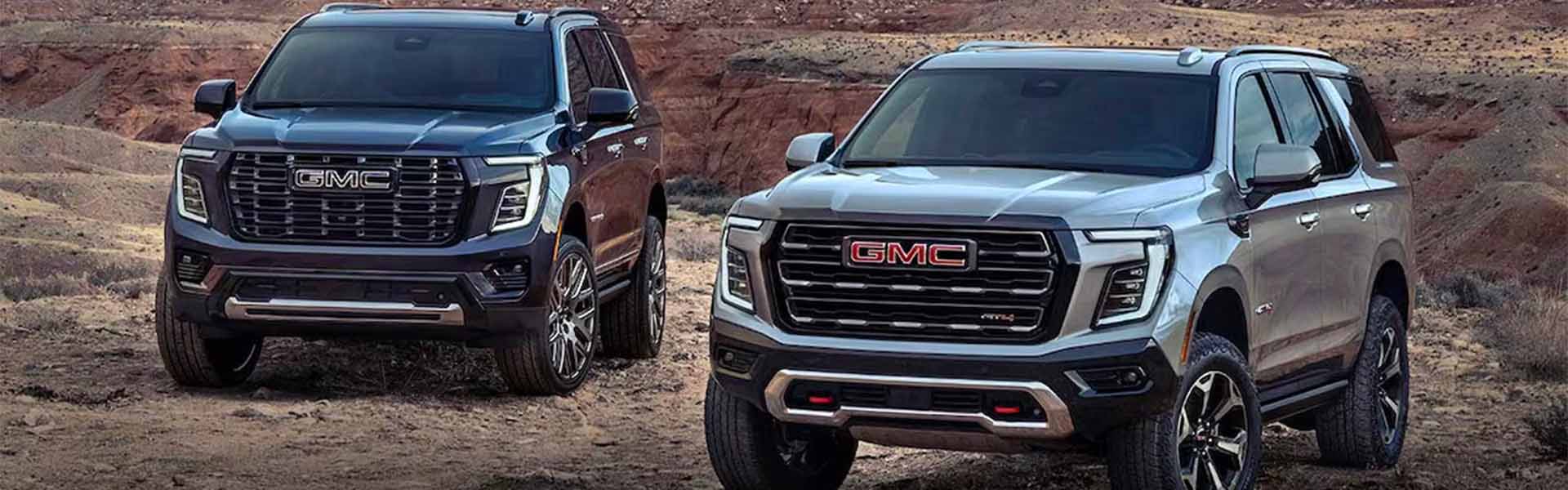 A black and silver Yukon car parked on off road