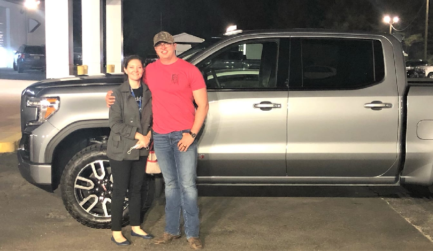 Couple in front of gray truck
