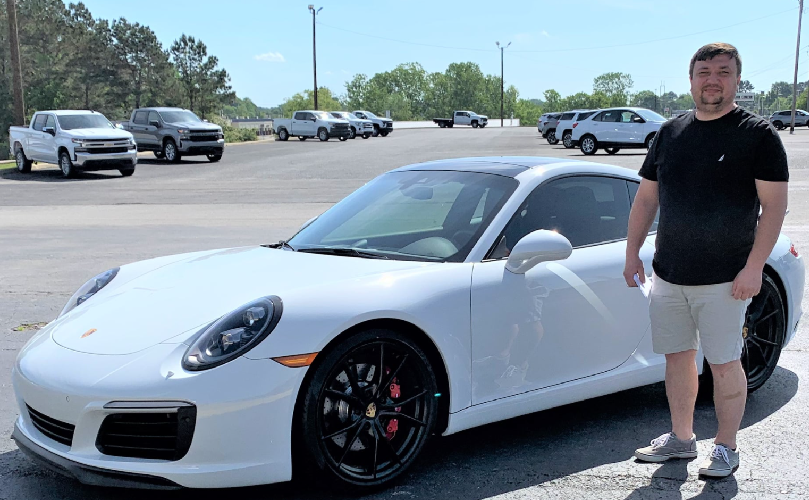 Man in front of new car at Glynn Smith Chevrolet Buick GMC