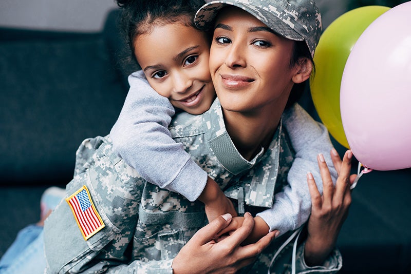 Military family in front of a car